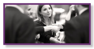 Image of a woman shaking hands at a networking event
